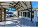 Covered carport with a recreational van next to the house with a sunroom and a landscaped yard at 21192 Knollwood Ave, Port Charlotte, FL 33952