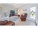 Comfortable living room featuring a large window, neutral color palette, and stylish furnishings at 21192 Knollwood Ave, Port Charlotte, FL 33952