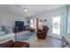 Bright living room with tile flooring, a comfortable recliner, and a decorative front door at 21192 Knollwood Ave, Port Charlotte, FL 33952