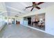 Sunroom featuring tile floors, ceiling fan, and sliding glass doors to a home office and to the dining/living room at 21192 Knollwood Ave, Port Charlotte, FL 33952