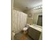 A bright bathroom with a vanity, decorative mirror, and shower at 22441 Westchester Blvd # 1100D, Port Charlotte, FL 33980