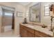 Bathroom featuring granite counters, stylish mirror, attractive light fixtures and walk-in shower at 2284 Palm Tree Dr, Punta Gorda, FL 33950