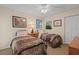 Bedroom with two twin beds features decorative wall art, ceiling fan and neutral toned carpet at 2284 Palm Tree Dr, Punta Gorda, FL 33950