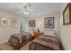 Bedroom with two twin beds features decorative wall art and a ceiling fan with light at 2284 Palm Tree Dr, Punta Gorda, FL 33950