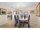 Inviting dining area with a modern chandelier, tile floors, and views into the kitchen at 2284 Palm Tree Dr, Punta Gorda, FL 33950