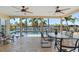 Relaxing covered patio area with ceiling fans, comfortable seating, and scenic water views at 2284 Palm Tree Dr, Punta Gorda, FL 33950