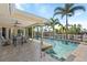 Inviting pool area with covered patio, ceiling fans, and views of the canal at 2284 Palm Tree Dr, Punta Gorda, FL 33950