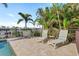 Inviting pool area featuring poolside lounge chairs and dining set with scenic canal views at 2284 Palm Tree Dr, Punta Gorda, FL 33950