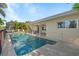 Beautiful pool with covered patio and canal view, surrounded by lush tropical landscaping at 2284 Palm Tree Dr, Punta Gorda, FL 33950