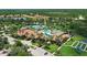 Aerial view of community center featuring a pool, tennis courts, and beautiful landscaping at 2478 Brassica Dr, North Port, FL 34289