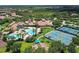 A high angle shows the community center with swimming pools, tennis courts and green spaces at 2478 Brassica Dr, North Port, FL 34289