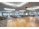 Large ballroom featuring hardwood floors, chandeliers, and ample seating for gatherings at 2478 Brassica Dr, North Port, FL 34289