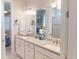 Bathroom vanity featuring dual sinks, a bright mirror, and modern fixtures at 2478 Brassica Dr, North Port, FL 34289