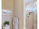 Neutral powder room with a framed starfish art piece above the toilet and a glass enclosed shower in the background at 2478 Brassica Dr, North Port, FL 34289