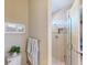 Powder room featuring a shower with glass door, toilet, towel rack, and framed artwork at 2478 Brassica Dr, North Port, FL 34289