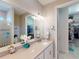 Bathroom featuring a large mirror, double vanity and view of the walk-in closet at 2478 Brassica Dr, North Port, FL 34289