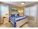 Bright bedroom featuring plantation shutters, ceiling fan, and coastal-themed decor at 2478 Brassica Dr, North Port, FL 34289