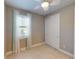 Neutral bedroom with tile floors, large window, and a closet with sliding doors at 2478 Brassica Dr, North Port, FL 34289