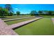 Enjoy the community bocce ball court with manicured lawns in a lush setting overlooking the pond and neighborhood at 2478 Brassica Dr, North Port, FL 34289