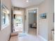 Bright foyer featuring tile flooring, a decorative mirror, and views into the adjacent rooms at 2478 Brassica Dr, North Port, FL 34289