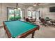 Community game room featuring a billiard table, poker table, and comfortable seating at 2478 Brassica Dr, North Port, FL 34289