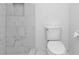 Modern bathroom with white marble tiled walk-in shower and toilet at 25068 Harborview Rd # 3B, Punta Gorda, FL 33980