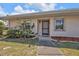 Charming front entrance with a well-kept lawn and colorful flower bushes adding to the curb appeal at 25068 Harborview Rd # 3B, Punta Gorda, FL 33980