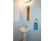 Well-lit bathroom with a pedestal sink, mirrored cabinet, and a blue towel at 255 West End Dr # 1302, Punta Gorda, FL 33950