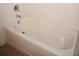 Clean white bathtub with tile surround and chrome fixtures at 255 West End Dr # 1302, Punta Gorda, FL 33950