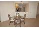 Cozy dining area featuring a glass table, wicker chairs, and a modern light fixture at 255 West End Dr # 1302, Punta Gorda, FL 33950