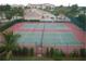 Overhead shot of well-maintained tennis courts with tropical landscaping at 255 West End Dr # 1302, Punta Gorda, FL 33950