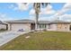 Single-story home with concrete driveway, two car garage, stone accents, and mature landscaping at 26166 Paysandu Dr, Punta Gorda, FL 33983