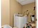 Laundry room with a full-size washing machine and dryer at 26166 Paysandu Dr, Punta Gorda, FL 33983