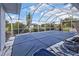 A covered pool is seen with lush landscaping visible through the screen at 26166 Paysandu Dr, Punta Gorda, FL 33983