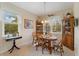 Bright dining area featuring a wooden table, cushioned chairs, and a window view at 2621 San Maria Cir, North Port, FL 34286