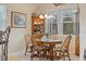 Cozy dining area with a wooden table, cushioned chairs, and natural light at 2621 San Maria Cir, North Port, FL 34286