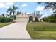 Well-maintained single-Gathering home with a two-car garage and an inviting landscaped front yard at 2621 San Maria Cir, North Port, FL 34286