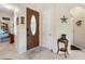 Inviting foyer featuring decorative glass front door and neutral tile flooring, and easy access to living areas at 2621 San Maria Cir, North Port, FL 34286