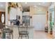 Well-lit kitchen featuring white cabinets, stainless steel appliances, granite countertops, and barstool seating at 2621 San Maria Cir, North Port, FL 34286