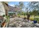 Relaxing screened patio with brick pavers, shade covering, and a variety of potted plants at 2621 San Maria Cir, North Port, FL 34286