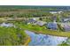 Aerial view of waterfront homes with lush landscaping, serene pond, and a tranquil neighborhood setting at 2639 Hobblebrush Dr, North Port, FL 34289