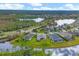 Aerial view of homes, ponds, and lush landscaping in a neighborhood, highlighting the community's serene setting at 2639 Hobblebrush Dr, North Port, FL 34289