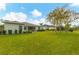 Lush green backyard showcases the home's exterior, landscaping, screened patio, and a tranquil atmosphere at 2639 Hobblebrush Dr, North Port, FL 34289