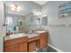 Bright bathroom features a double vanity and large mirror at 2639 Hobblebrush Dr, North Port, FL 34289