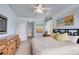 Spacious bedroom featuring a bed, ceiling fan, dresser, and windows that allow natural light at 2639 Hobblebrush Dr, North Port, FL 34289