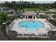 Aerial image of the community pool featuring a large pool deck, shade structures, and lounge seating at 2639 Hobblebrush Dr, North Port, FL 34289