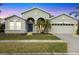 Charming single Gathering home featuring a two-car garage, arched entryway, and well-maintained landscaping at 2639 Hobblebrush Dr, North Port, FL 34289