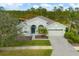 Beautiful home featuring a well-manicured lawn, arched entry, and a two-car garage in a serene neighborhood at 2639 Hobblebrush Dr, North Port, FL 34289