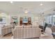 Bright living room featuring comfortable seating and a wall-mounted TV with sliding door access to the lanai at 2639 Hobblebrush Dr, North Port, FL 34289