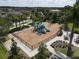 Aerial view of the community playground showing the play structure, fencing, and seating area at 2639 Hobblebrush Dr, North Port, FL 34289